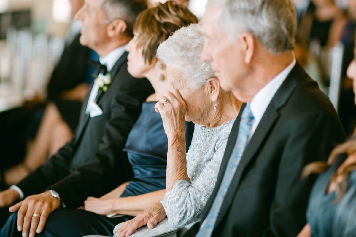 Grandmother crying at wedding ceremony.