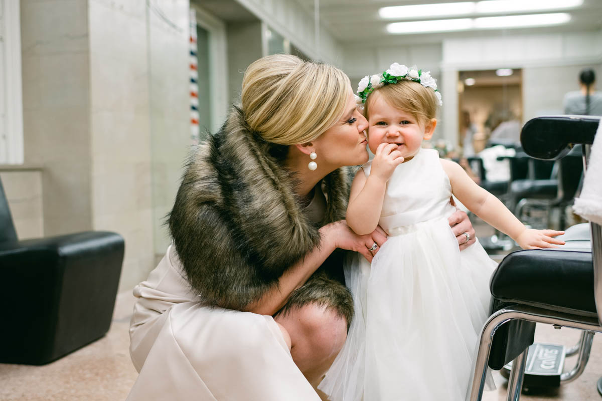 Bridesmaid playing with flower girl