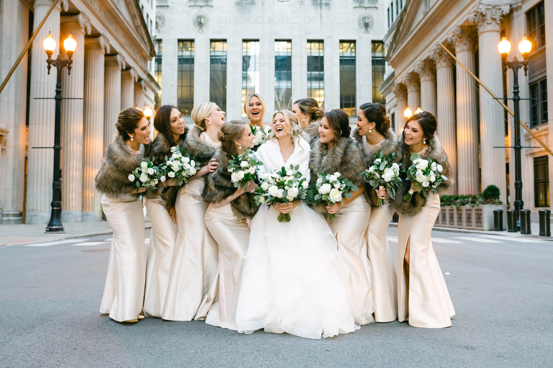 Bridesmaids in pink dresses posing for wedding photos at the Chicago Board of Trade Wedding
