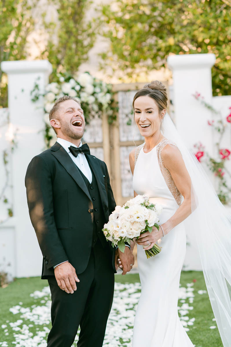Bride and groom laughing together in Arizona.