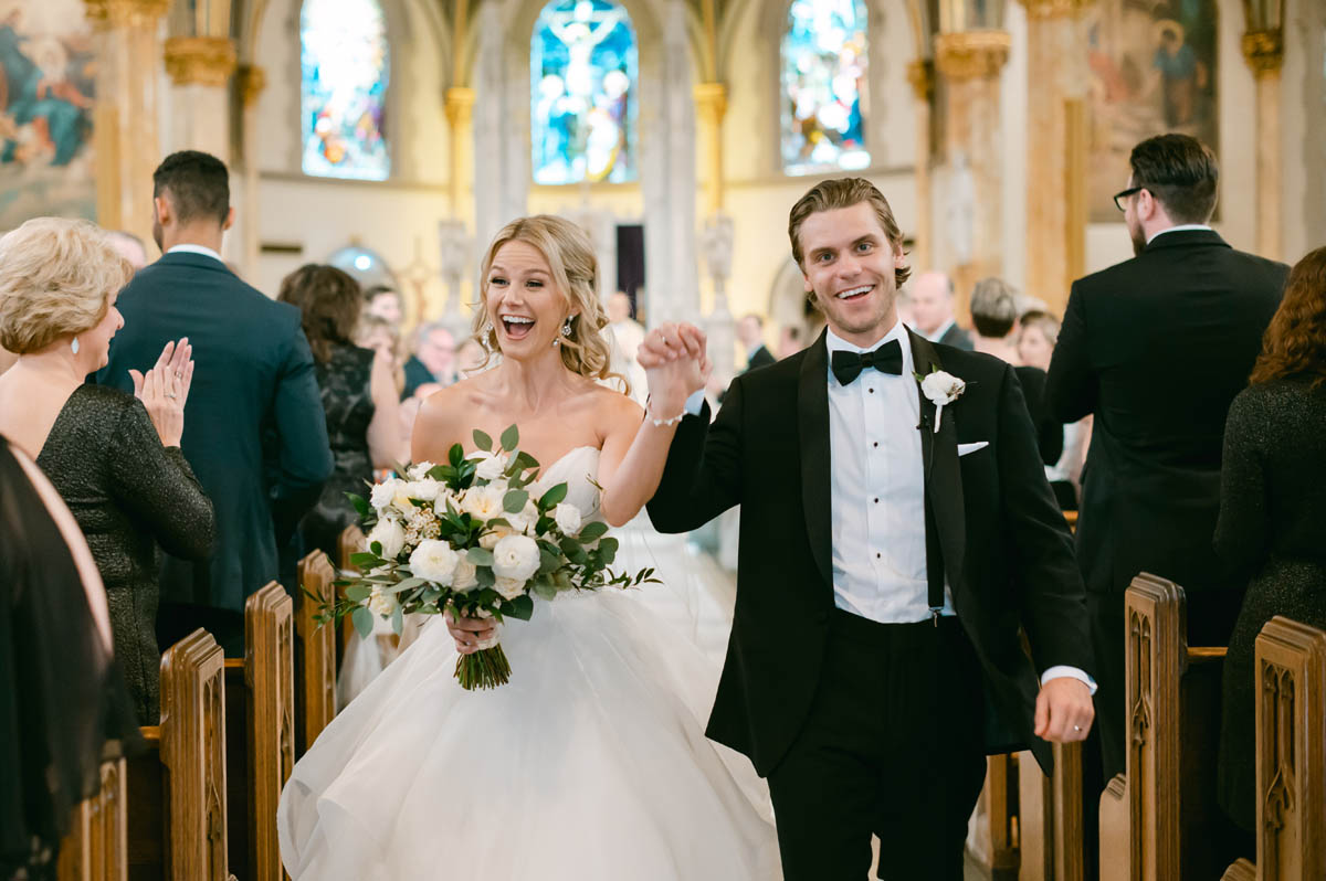 Happy couple walking down the aisle.
