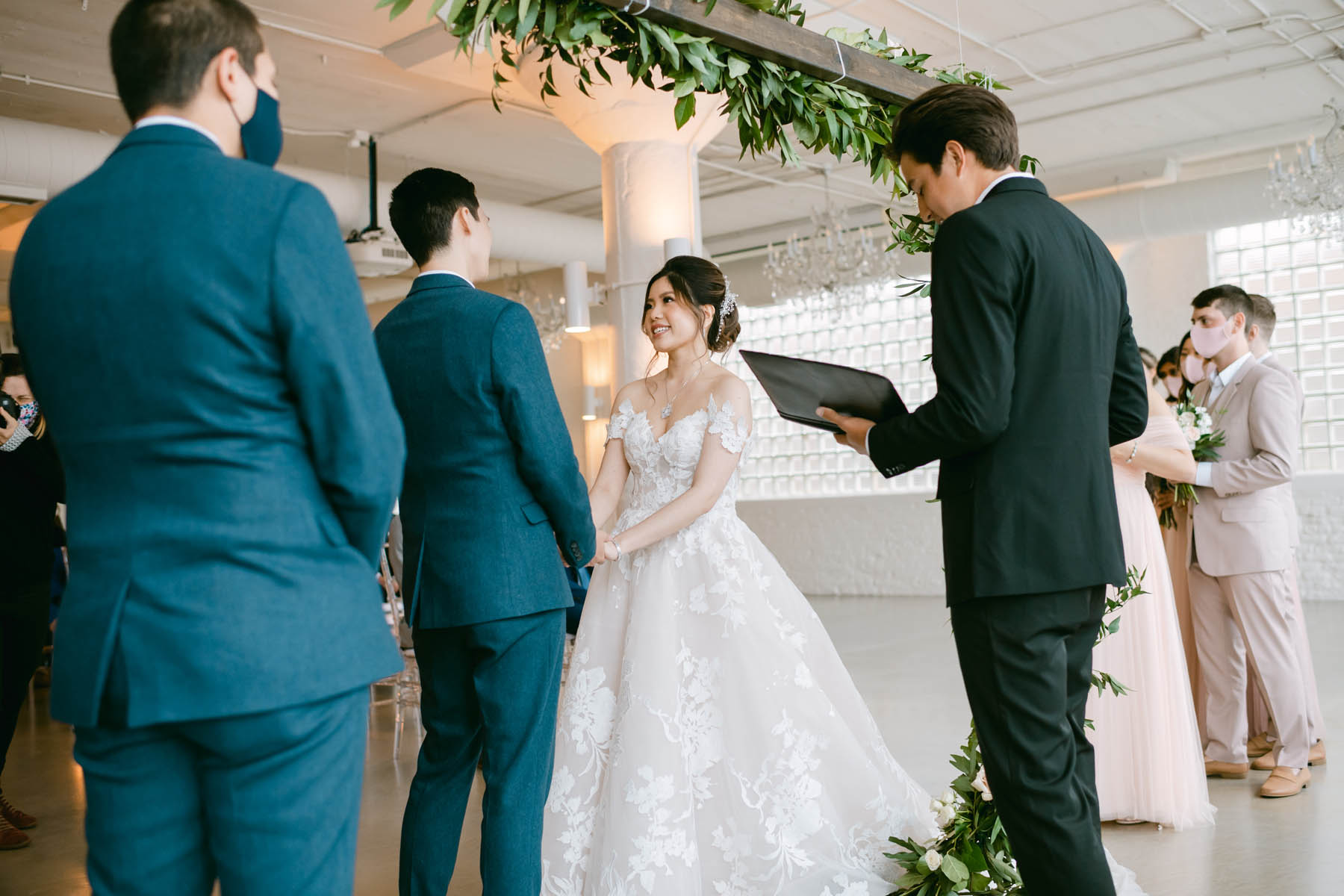 Bride looks adoringly at groom while they exchange vows.