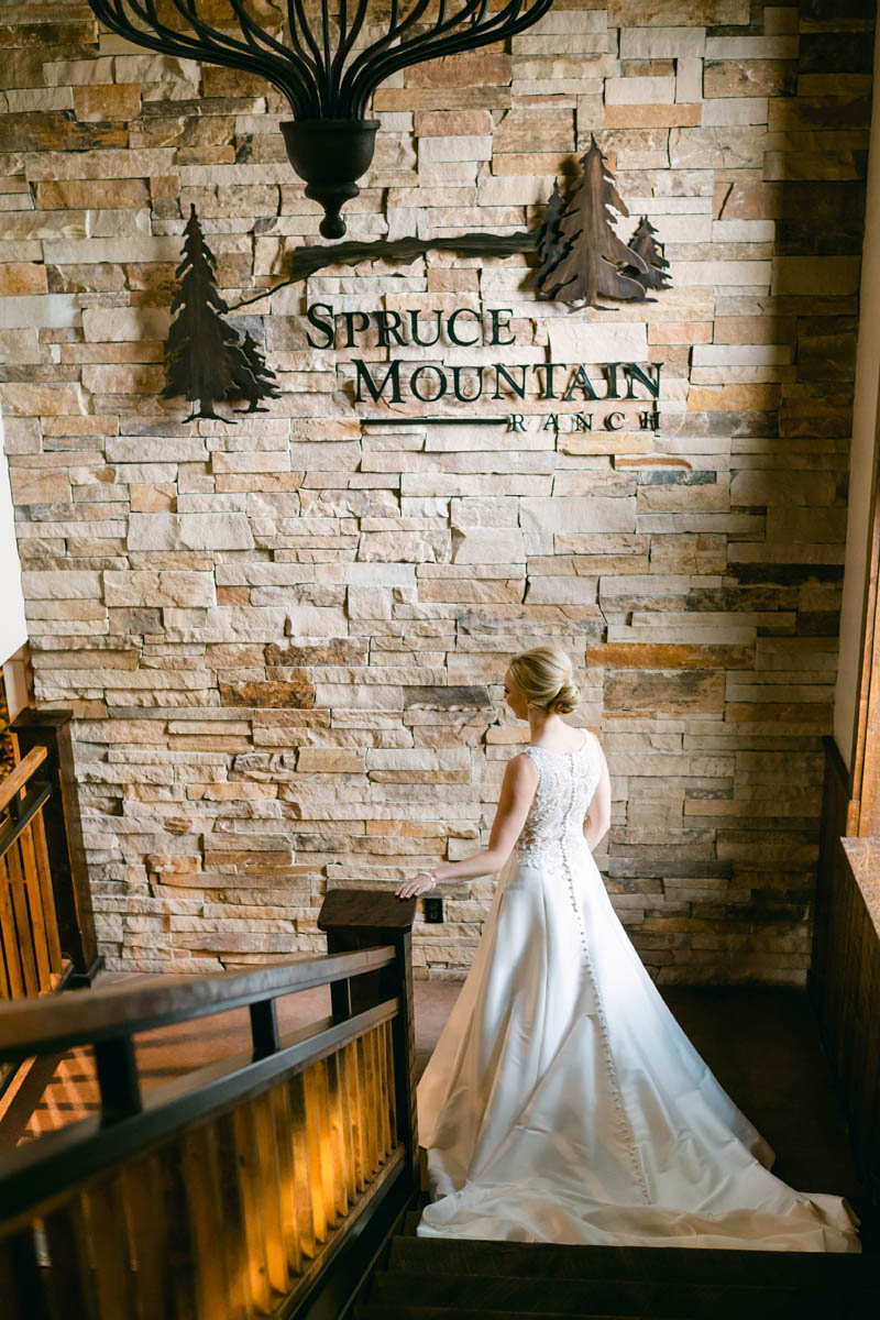 Bride walking down the stairs at Spruce Mountain Ranch.