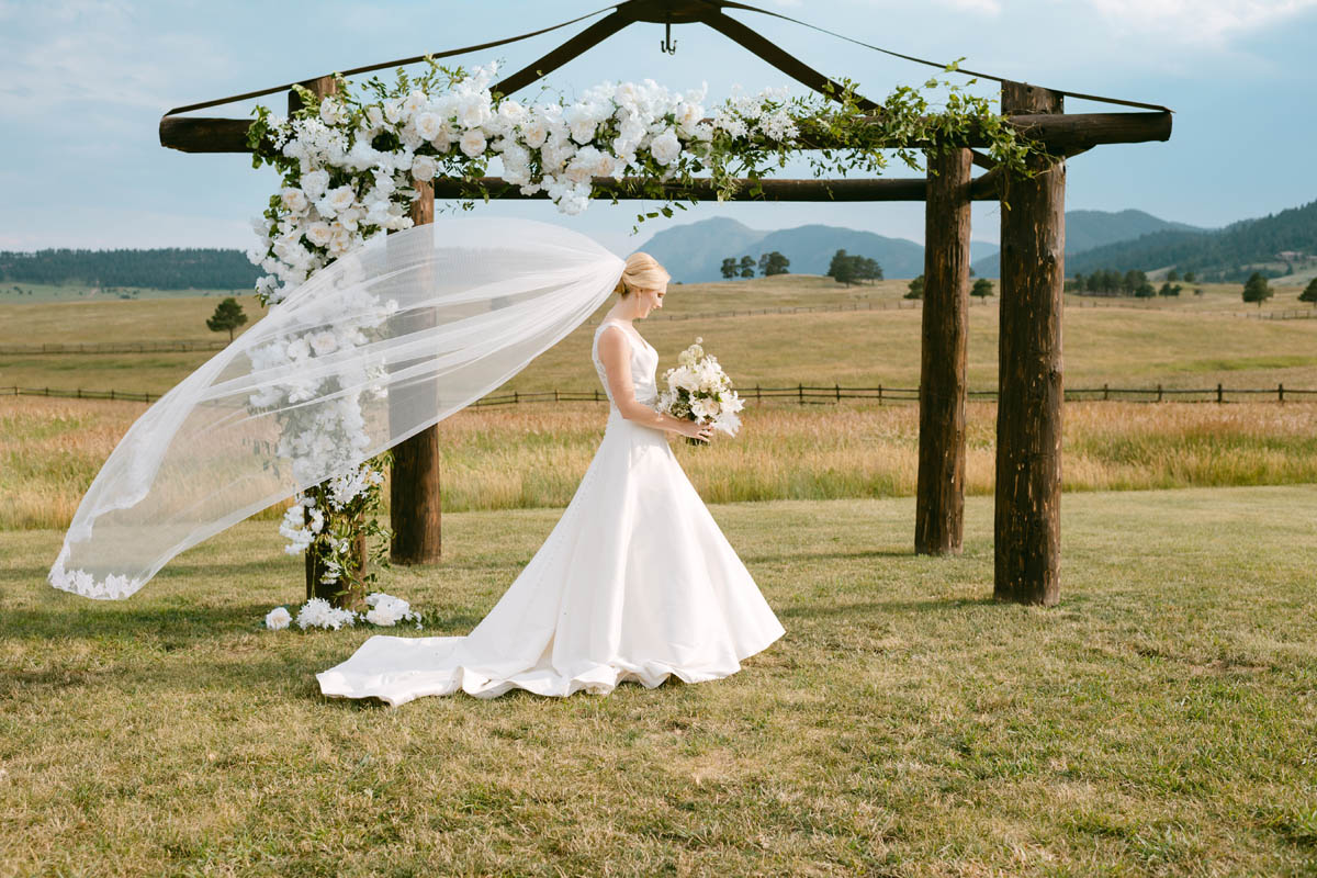 Bride poses for wedding photo in the sunlight Spruce Mountain Ranch