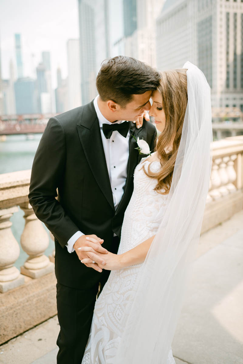 Couple posing for wedding photos at the Chicago Riverwalk