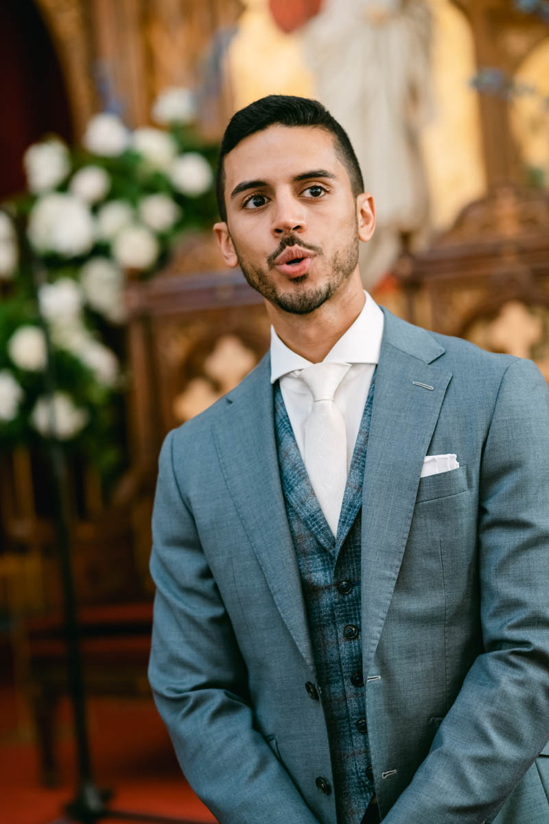 Emotional groom seeing his bride walking down the aisle.