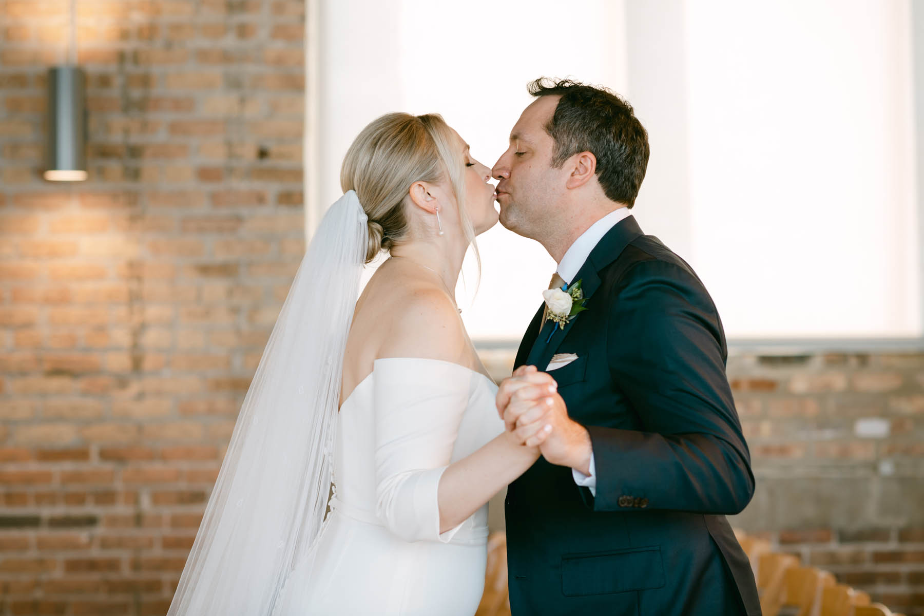 Bride and groom kiss after seeing each other.