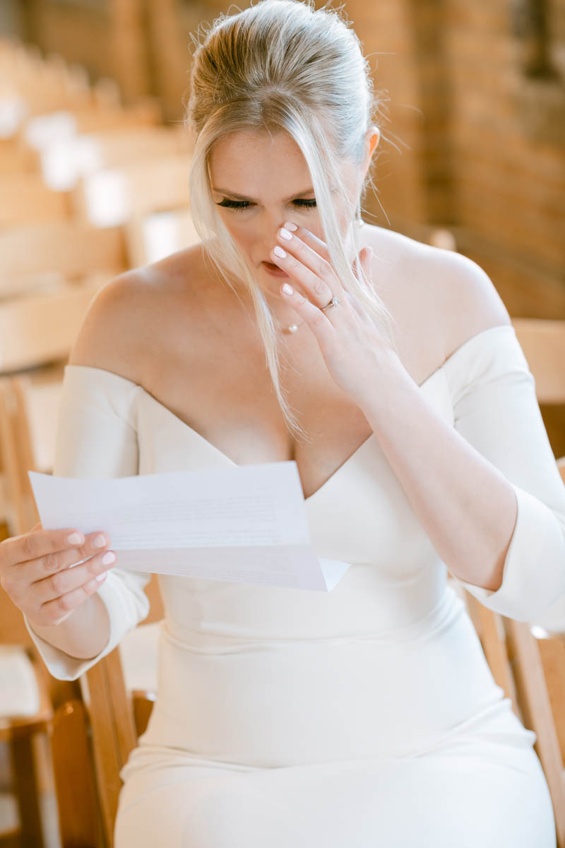 Bride crying reading letter from groom.