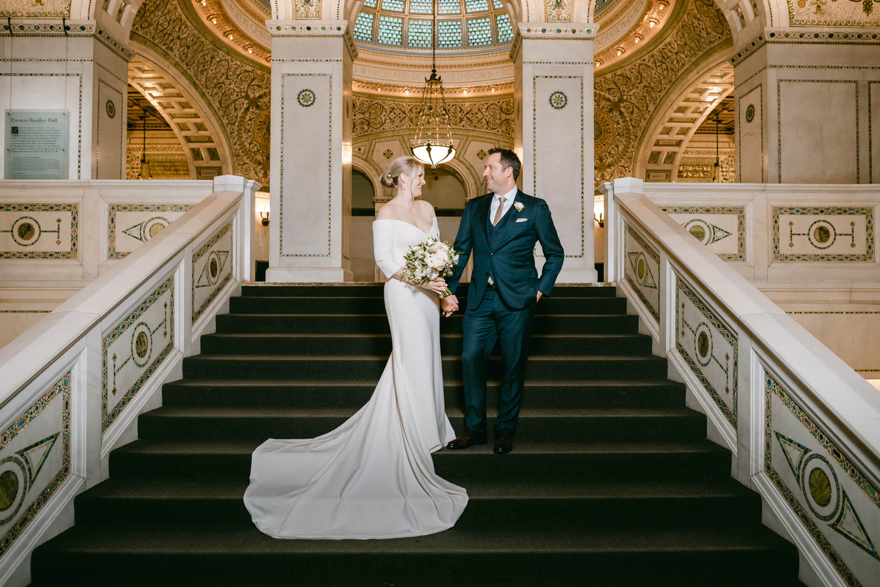 Anna looks at Brian as they pose for wedding photos at the Chicago Cultural Center.