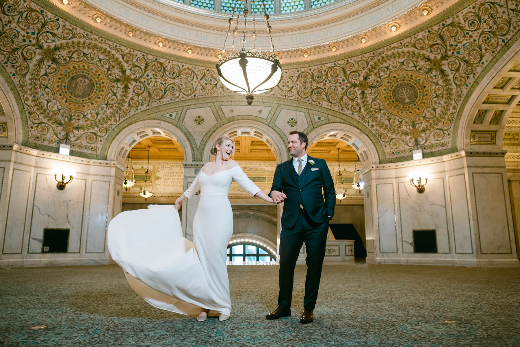 Bride and groom pose for wedding photos at the Chicago Cultural Center