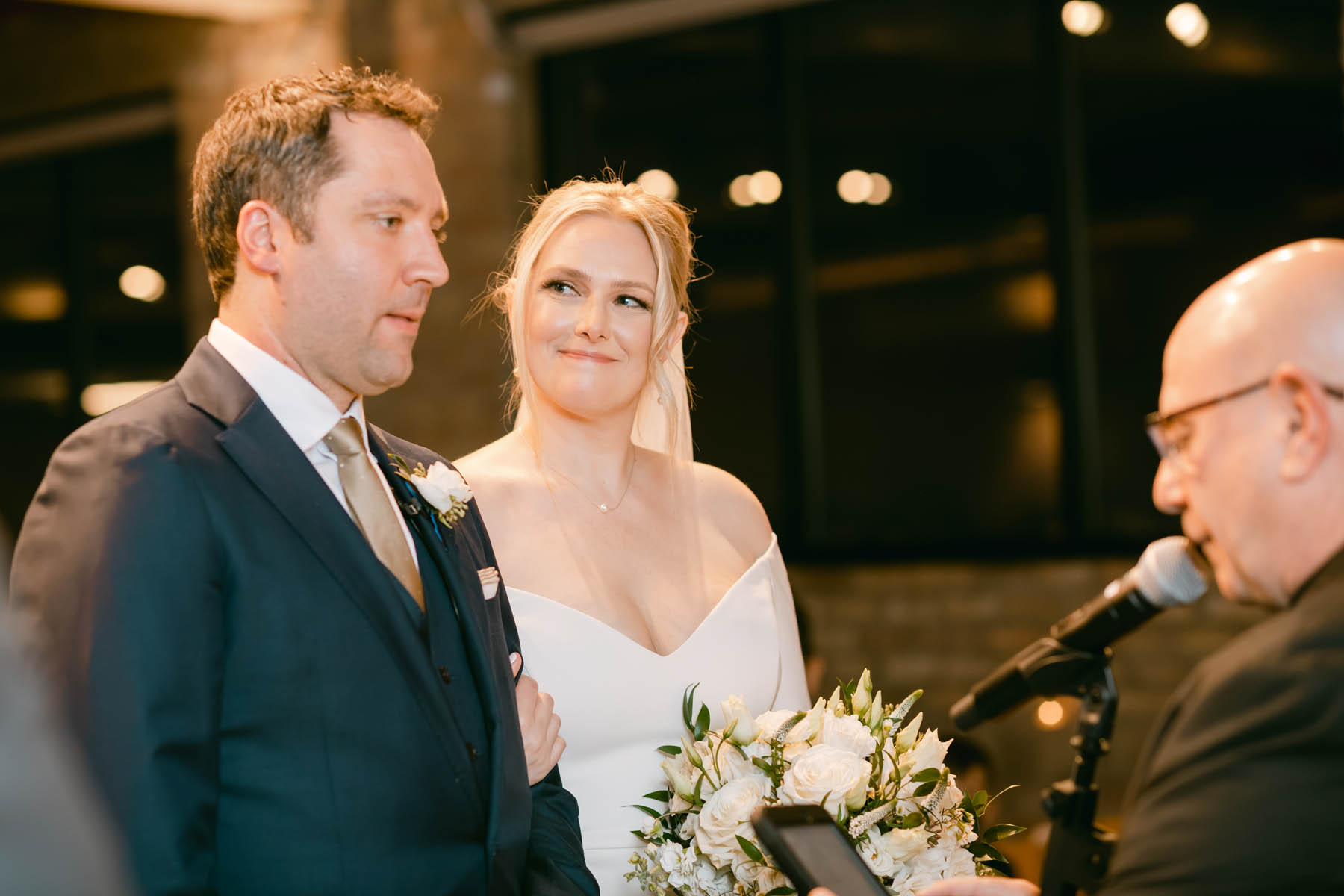 Bride looking at groom during wedding ceremony.