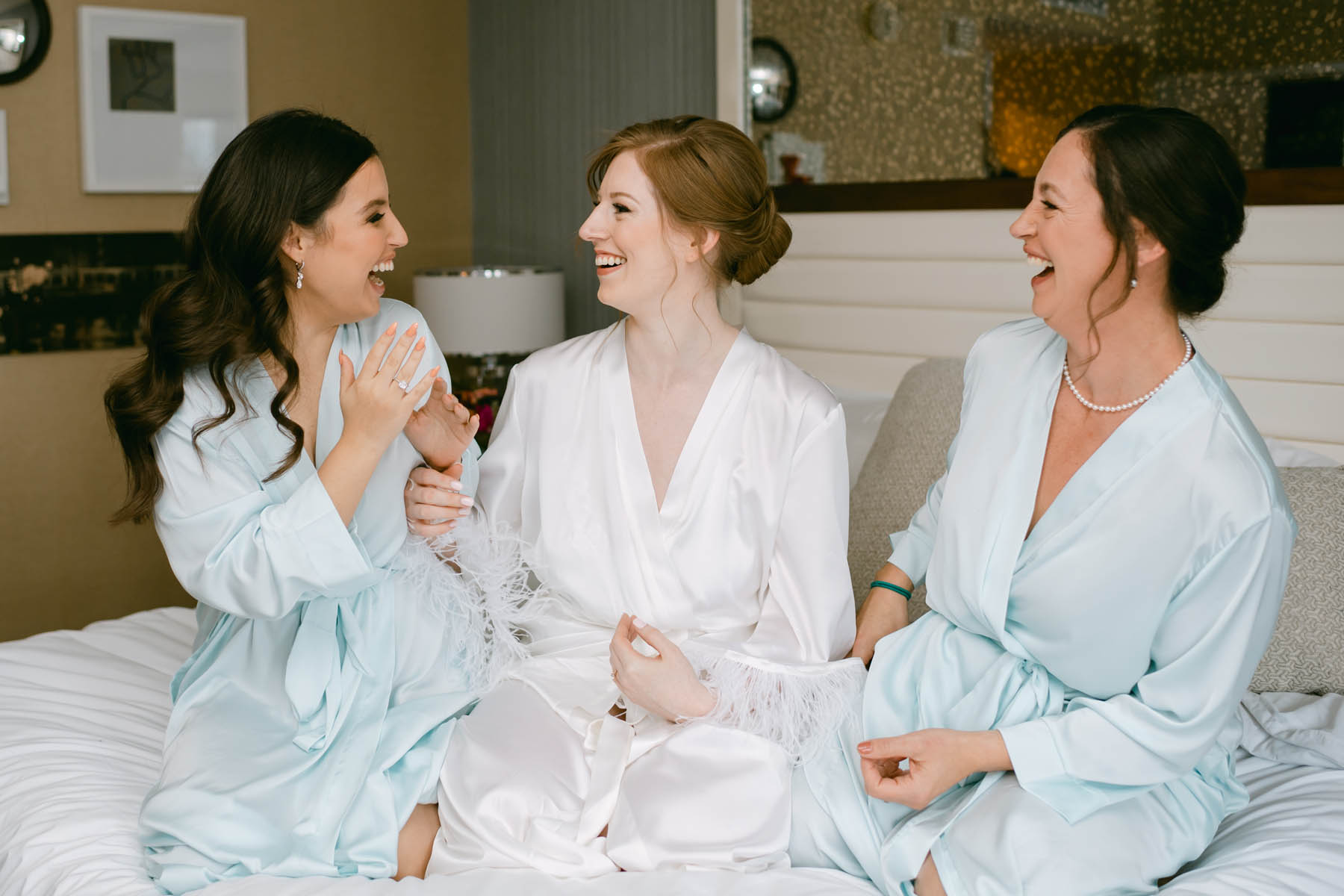 Bride laughing with her bridesmaids.