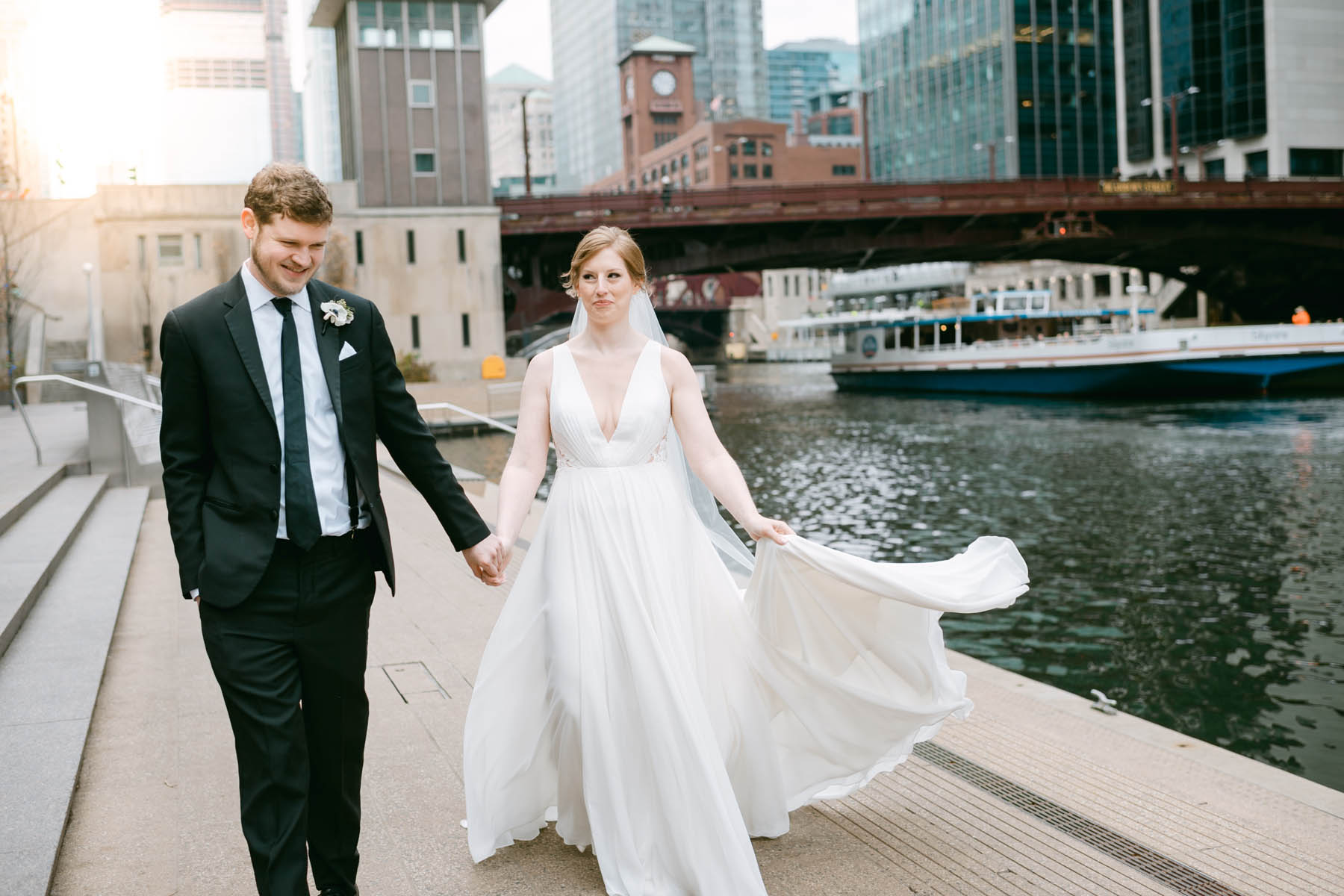 Wedding couple walk along the Chicago RIverwalk.