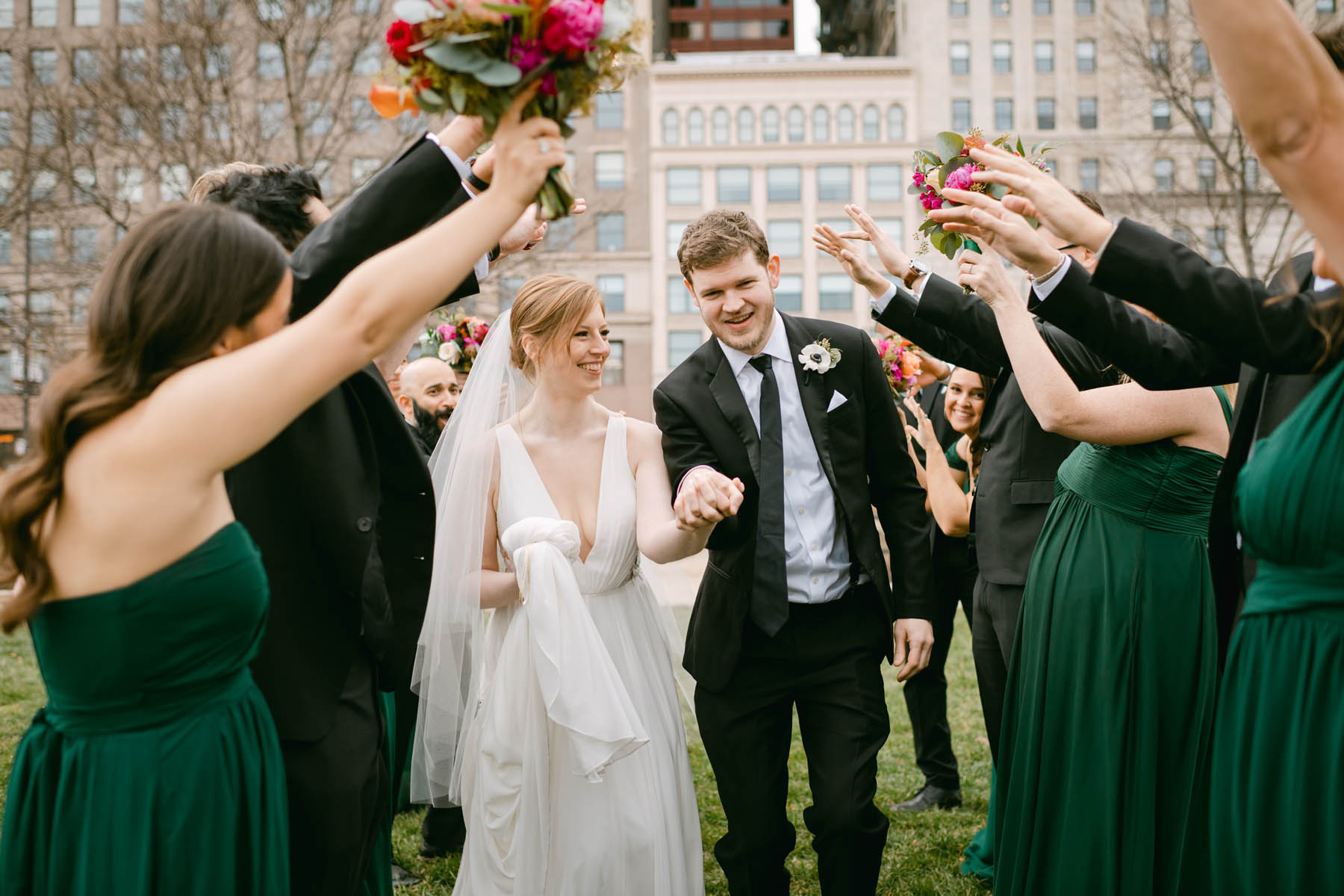 Happy wedding couple with bridal party at Grant Park.
