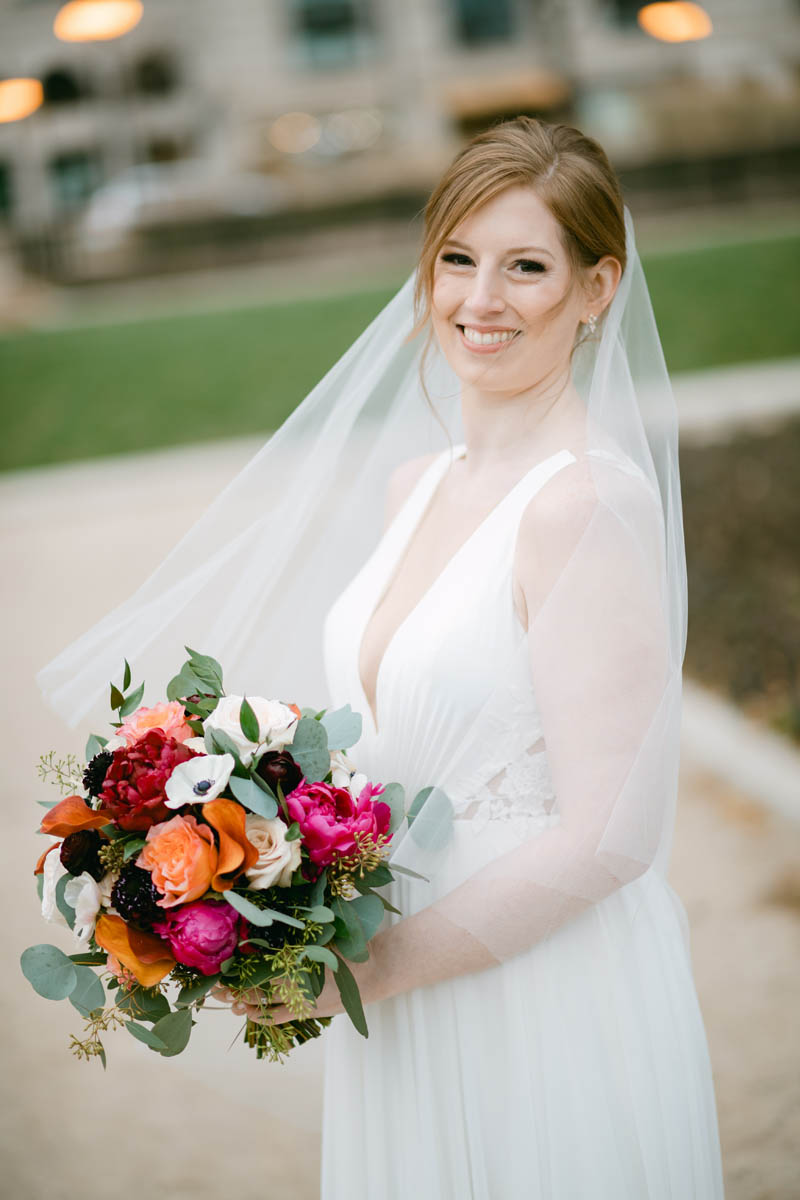 Beautiful bride with tropical flowers posing for wedding photo.