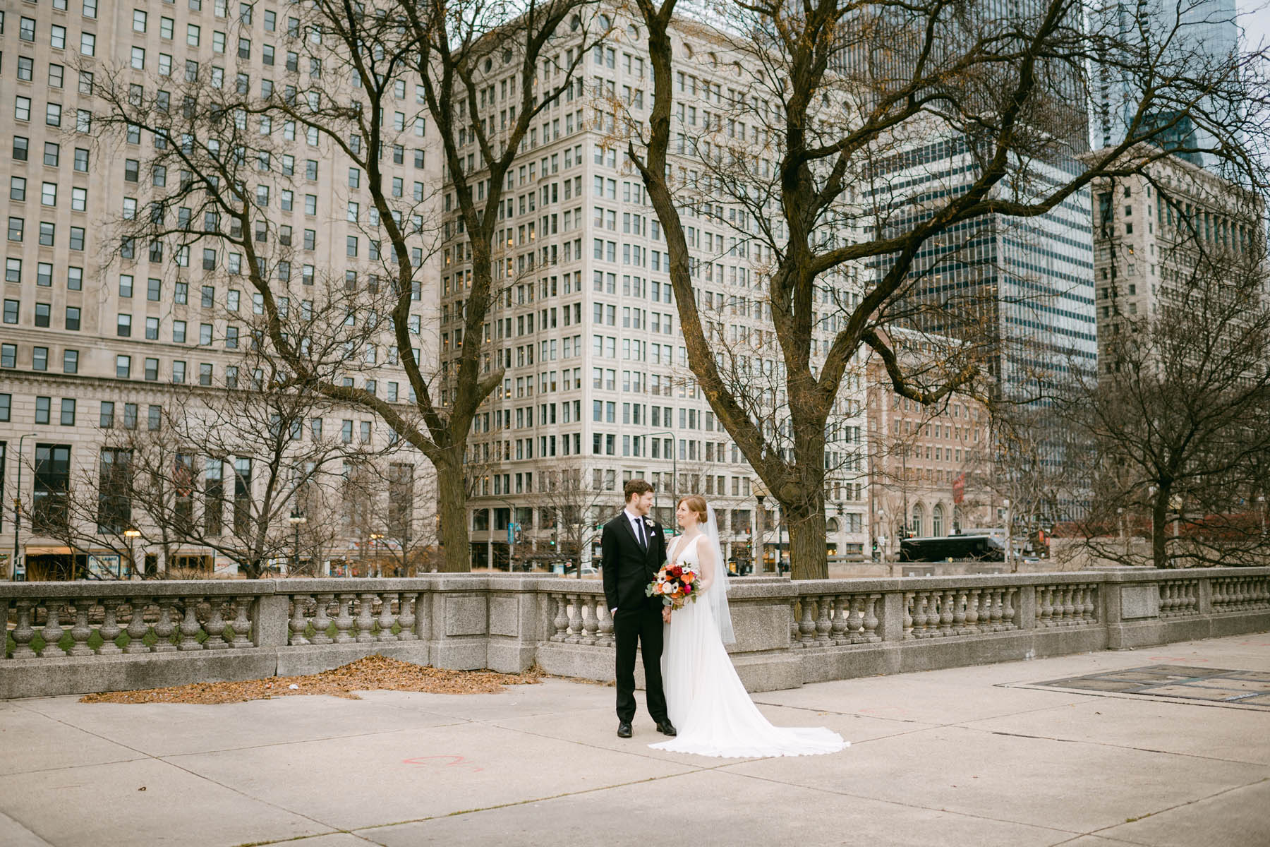 Wedding couple pose for winter wedding photos at Grant Park.