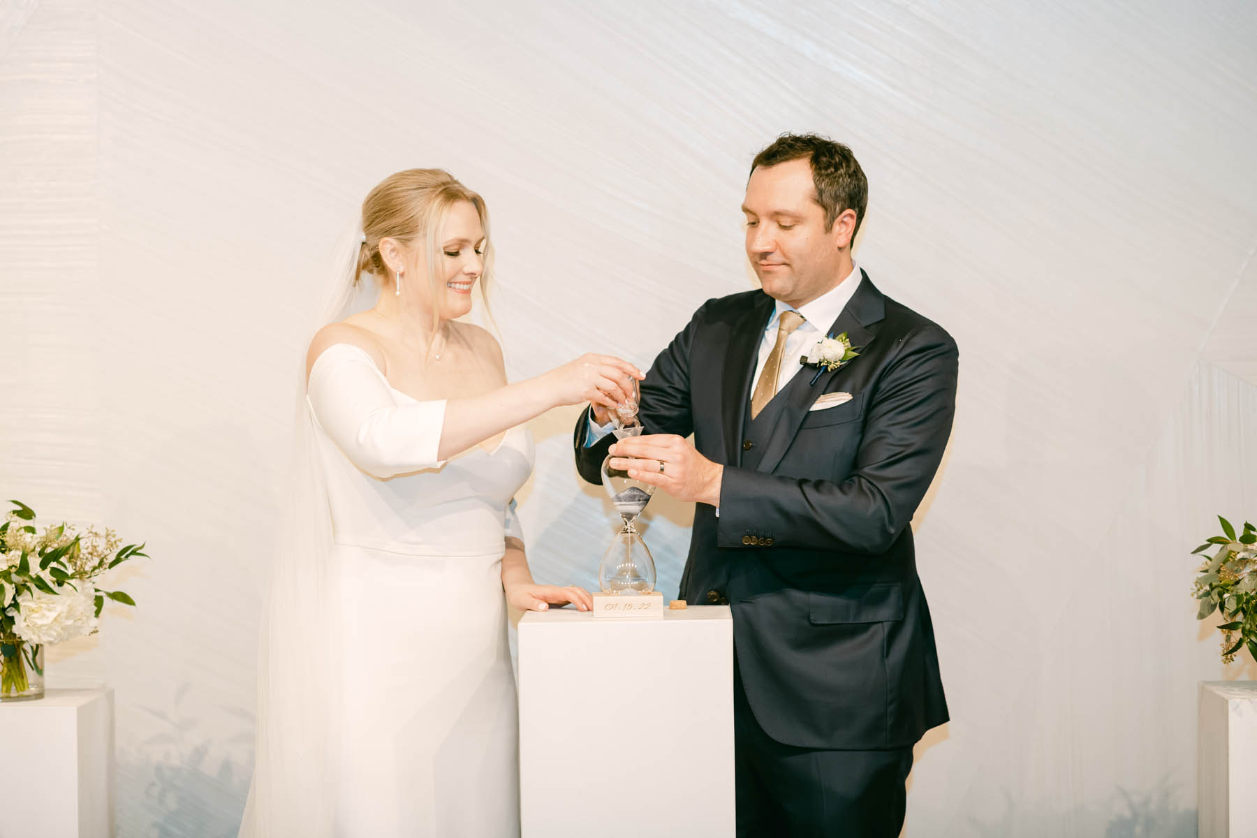 Bride and groom lighting unity candle.