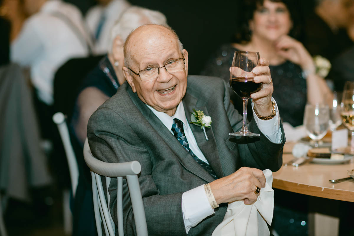 Grandpa toasting at wedding.