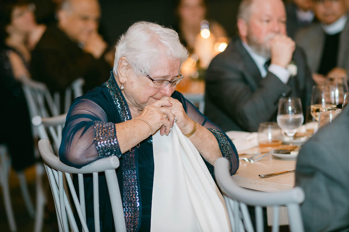 Grandma crying at wedding toast.
