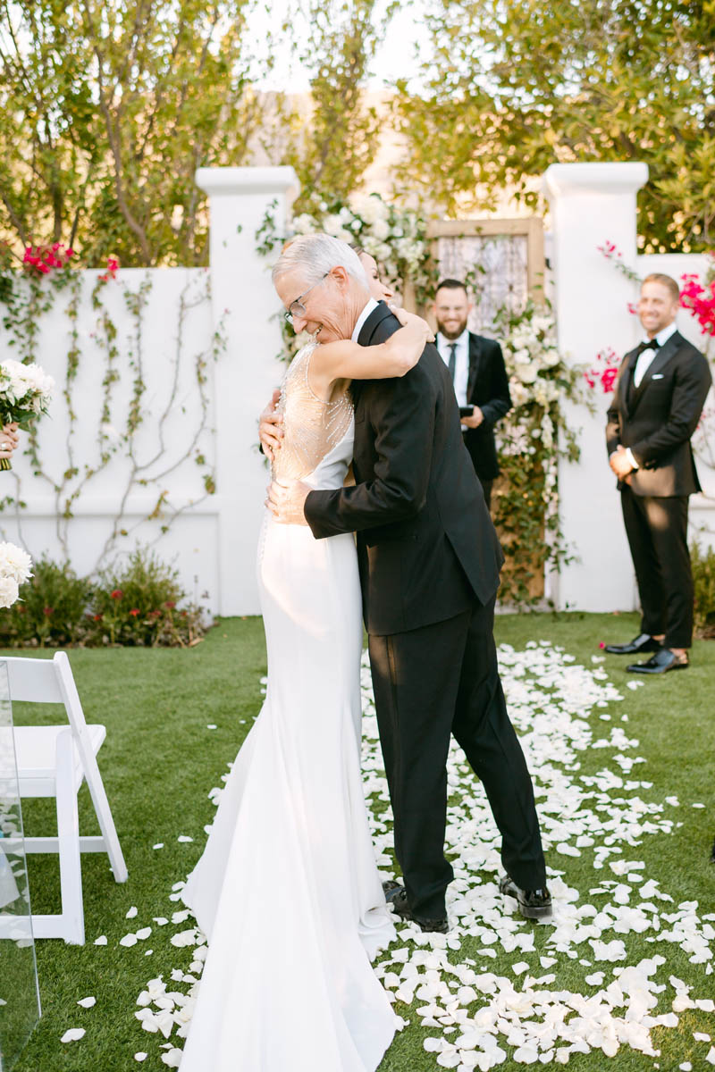 Bride hugging her Dad at the wedding ceremony.