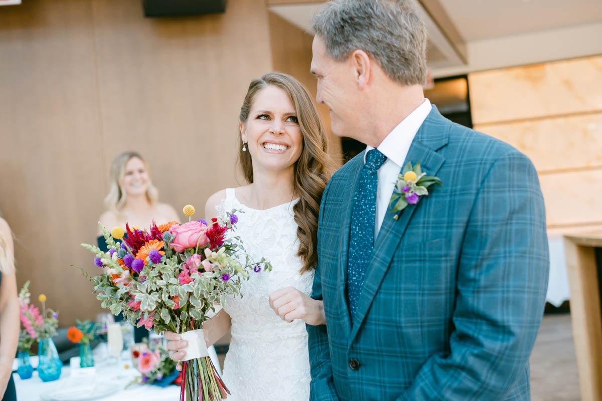 Bride looks at her dad walking down the aisle.