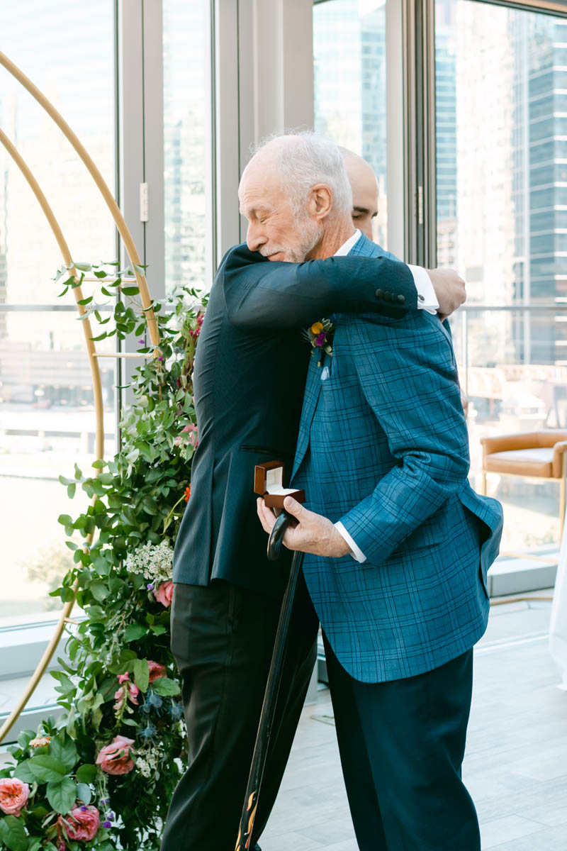 Grooms hugs his dad.