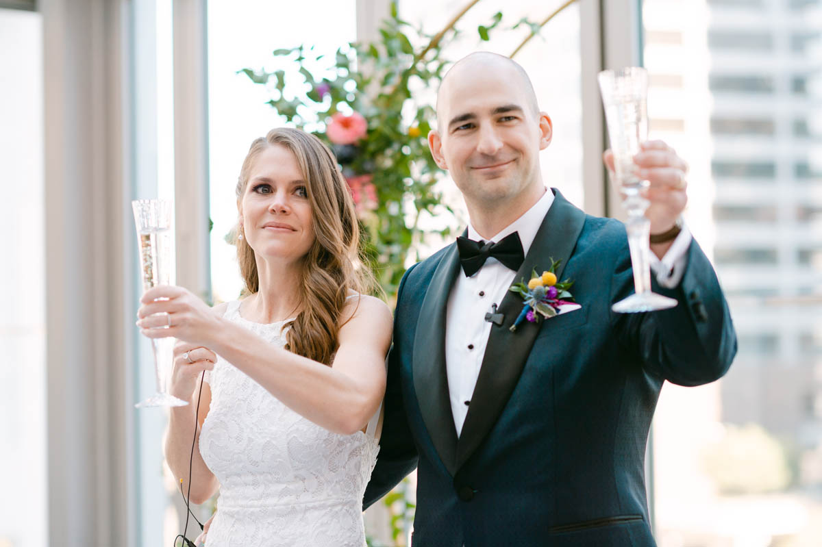 Bride and groom toasting at Gibsons Italia wedding.