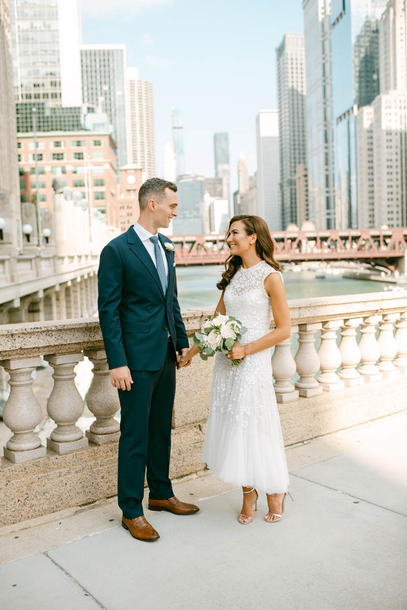 Wedding couple posing for photos on the Chicago Riverwalk.