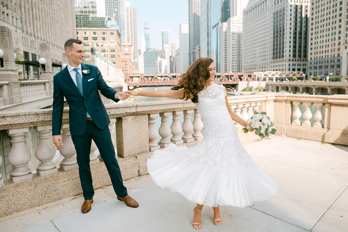 Wedding couple posing for photos on the Chicago Riverwalk.