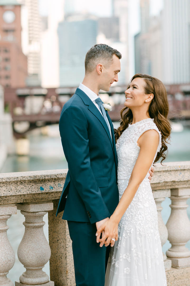 Wedding couple posing for photos on the Chicago Riverwalk.