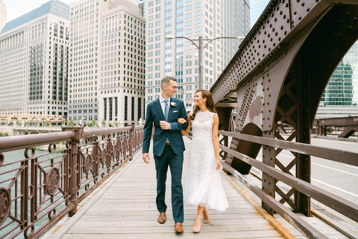 Wedding couple posing for photos on the Chicago Riverwalk.