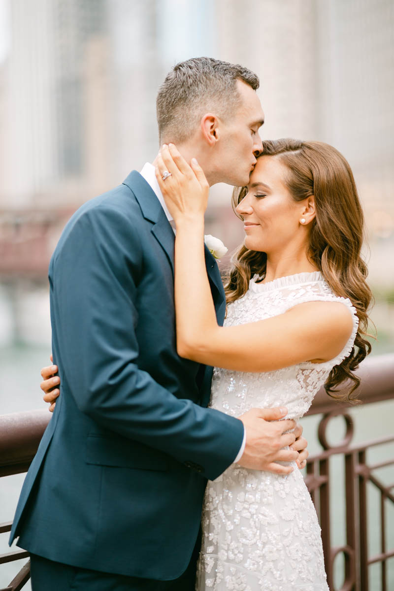 Wedding couple posing for photos on the Chicago Riverwalk.
