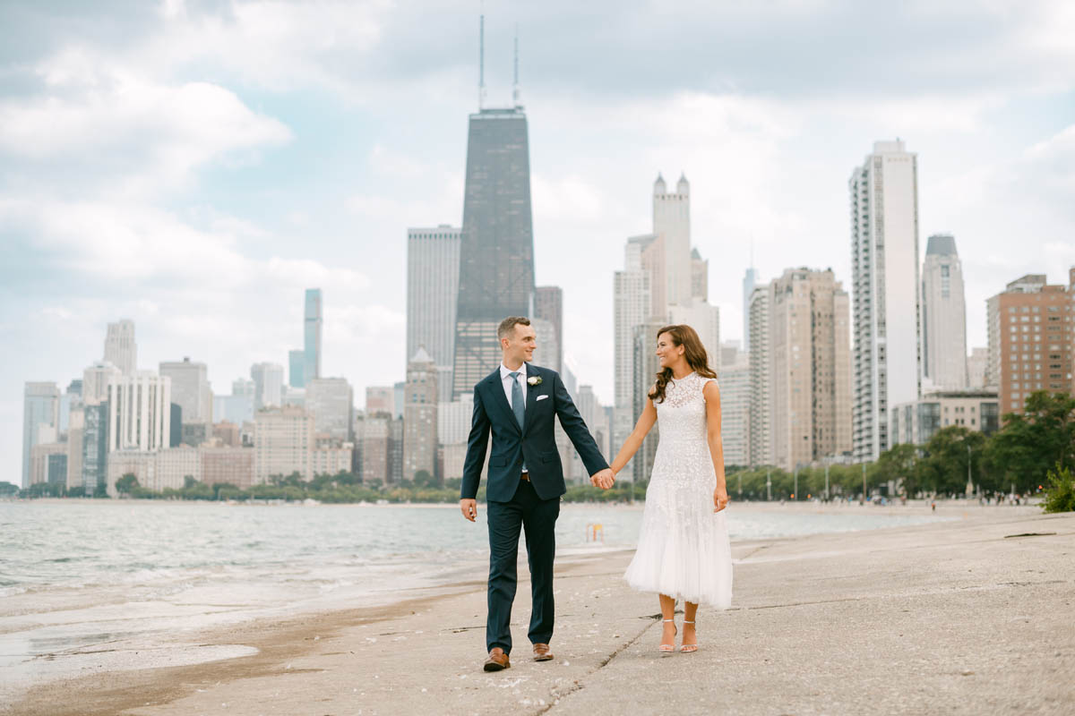 Wedding couple posing for photos at North Avenue Beach.