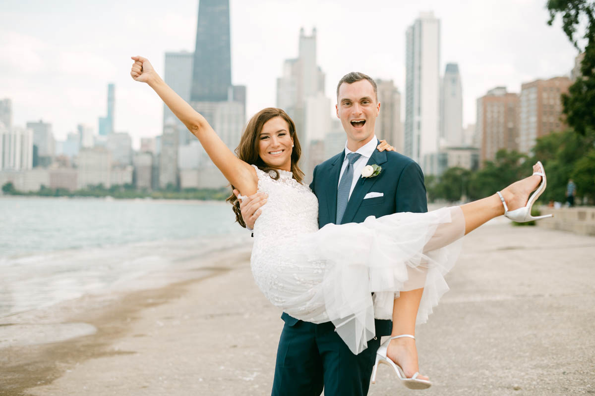 Wedding couple posing for photos at North Avenue Beach.