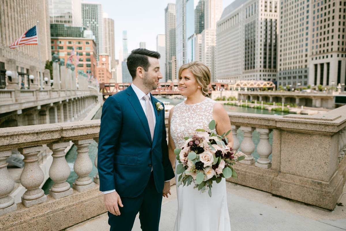 Wedding couple poses for photos along the Chicago Riverwalk.