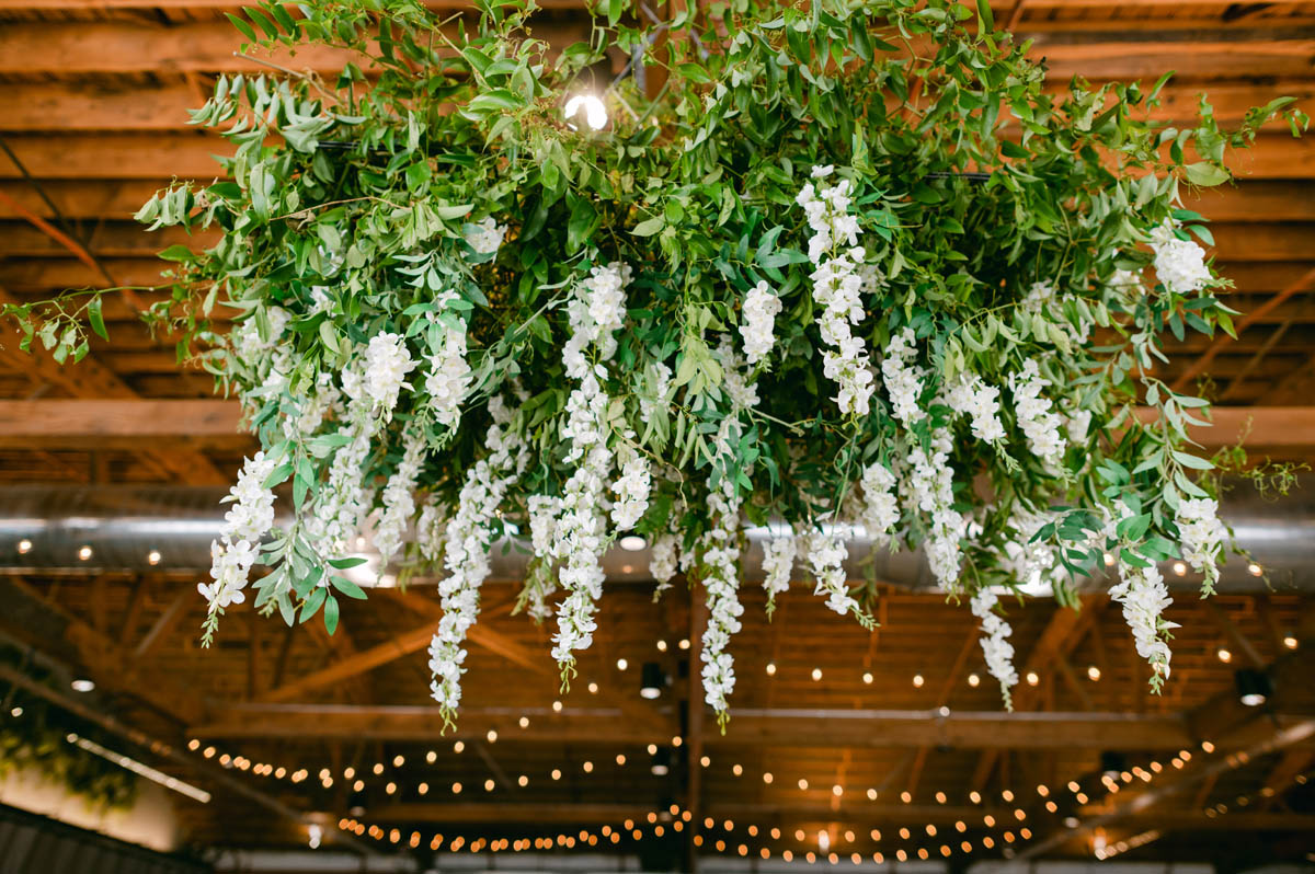 White wedding flowers hanging from the ceiling.
