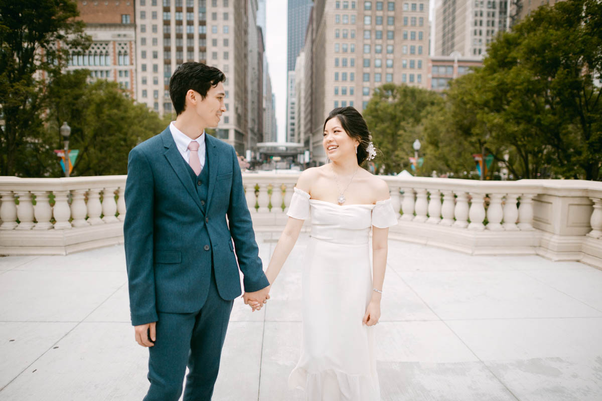 Wedding couple posing for photos at the Millennium Park.