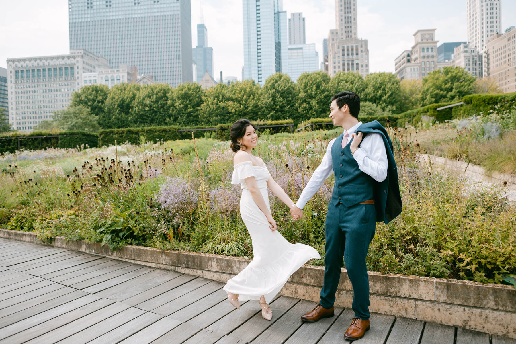 Wedding couple posing for photos at the Millennium Park Garden.