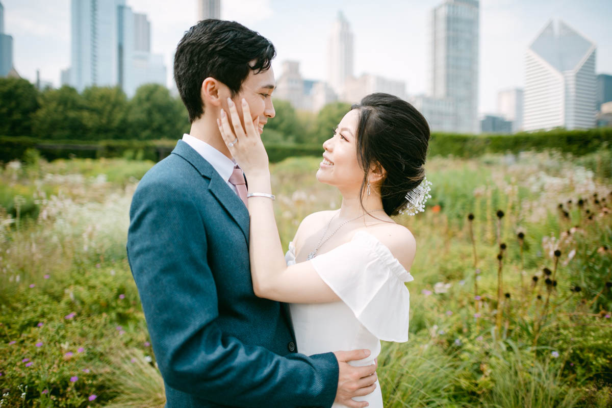 Wedding couple posing for photos at the Millennium Park Garden.