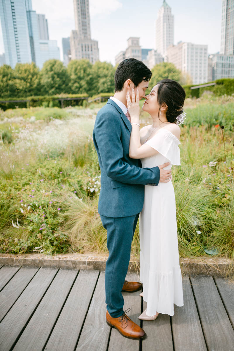 Wedding couple posing for photos at the Millennium Park Garden.