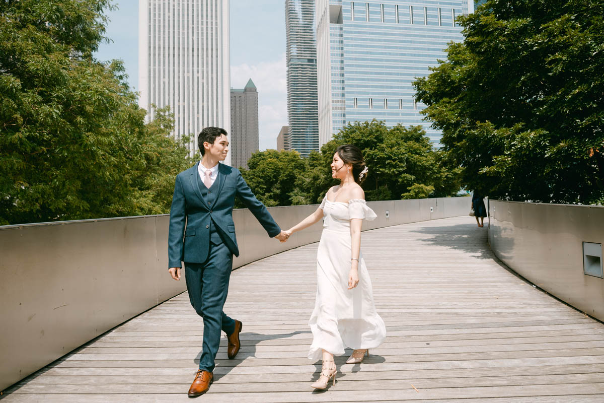 Wedding couple posing for photos at the Millennium Park Garden.