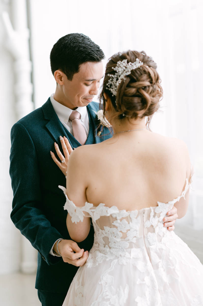 Emotional groom seeing his bride for first look.
