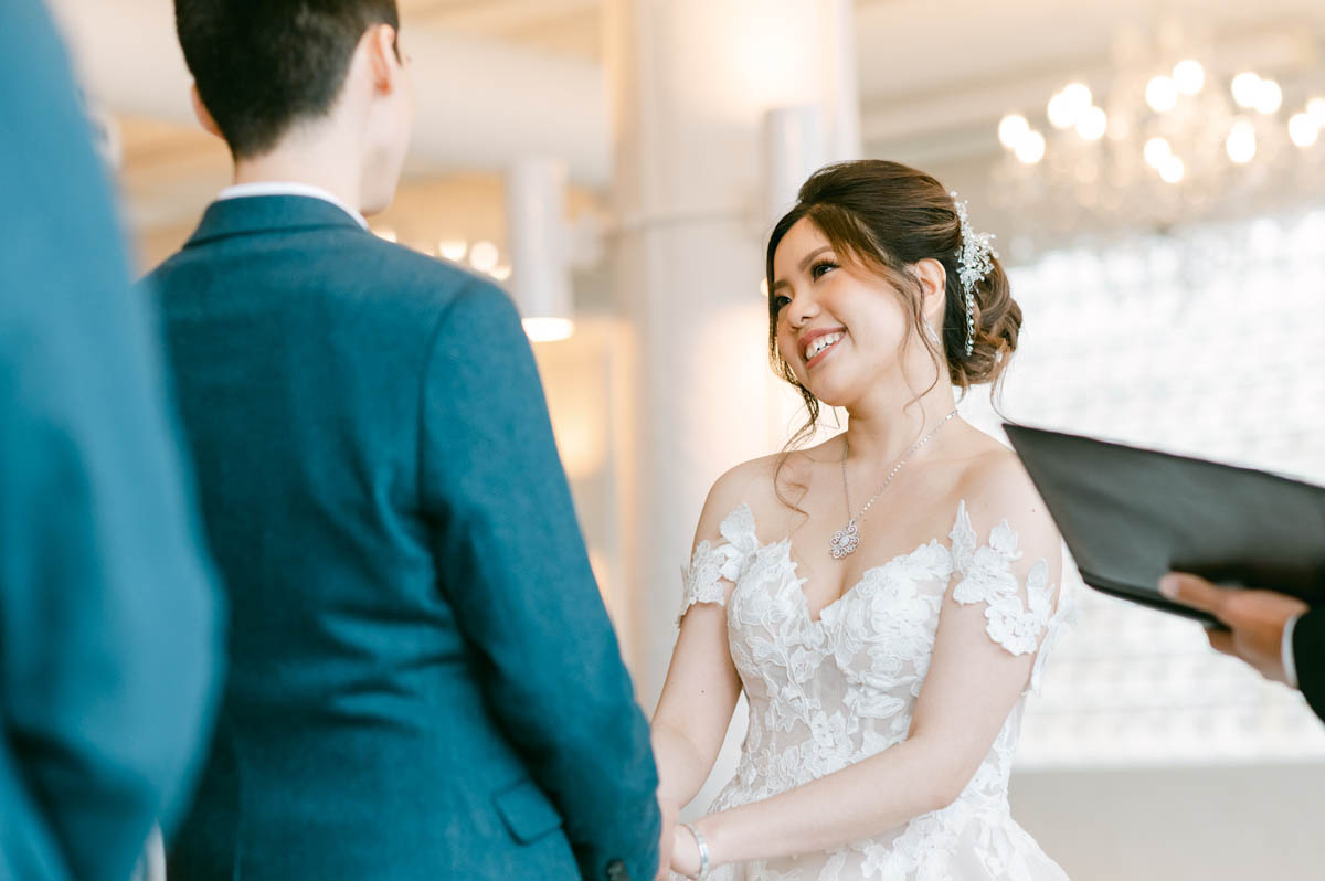 Bride looks adoringly at groom while they exchange vows.
