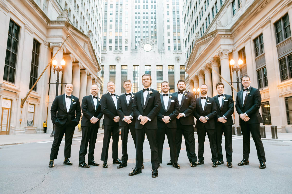 Groomsmen pose for wedding photos at the Chicago Board of Trade.