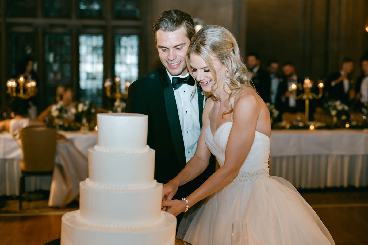 Bride and groom cutting the cake.