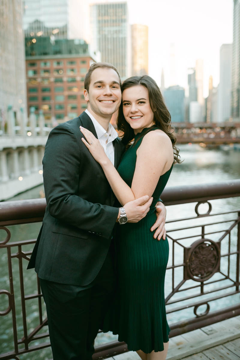Couple posing for engagement photos at the Chicago Riverwalk.