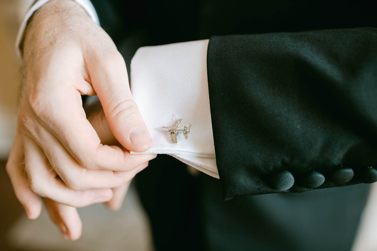 Creative wedding gift idea of airplane cufflinks.