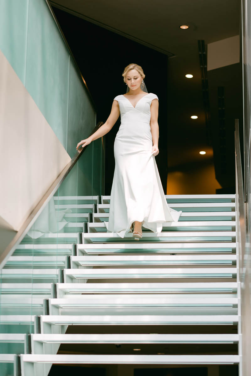 Bride walking down the stairs at the Hotel Sofitel