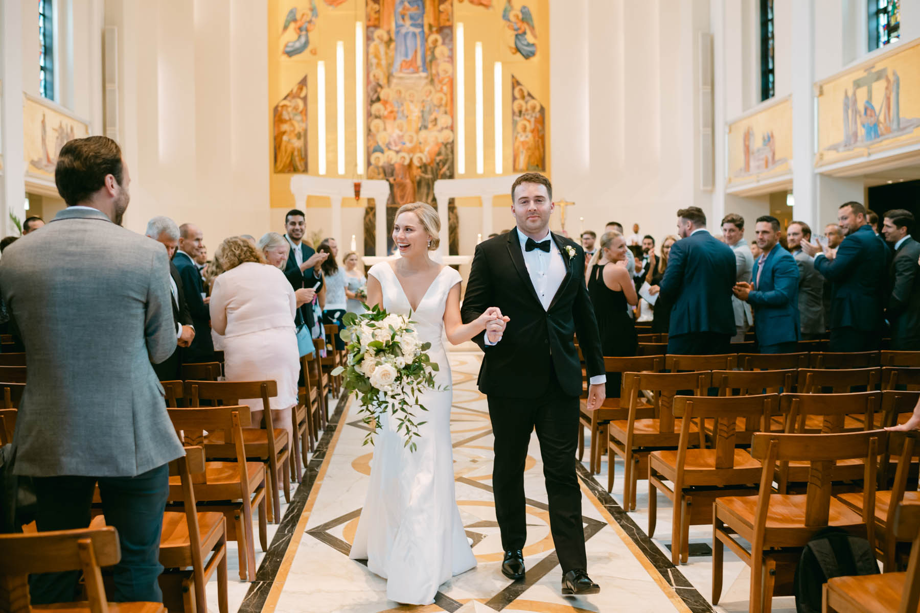 Wedding couple walking down the aisle at Madonna della strada chapel at Loyola.