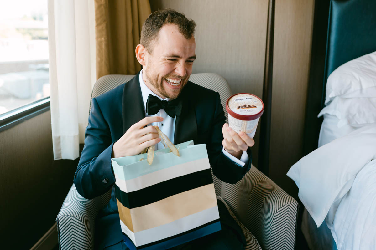 Groom opening her creative wedding gift from the bride.
